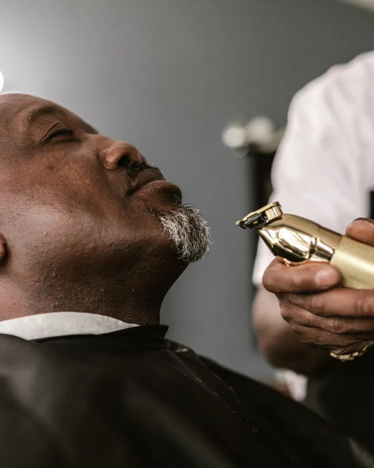 Barber sculpting a male client's beard